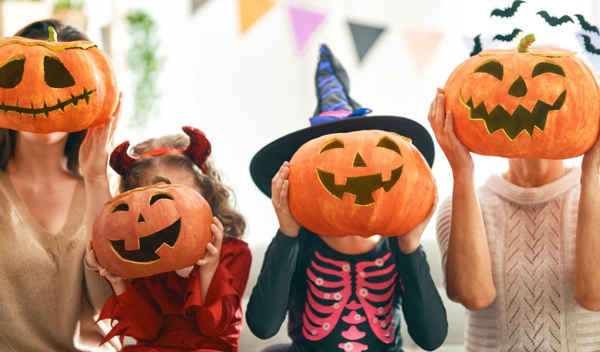 Kids holding pumpkin heads